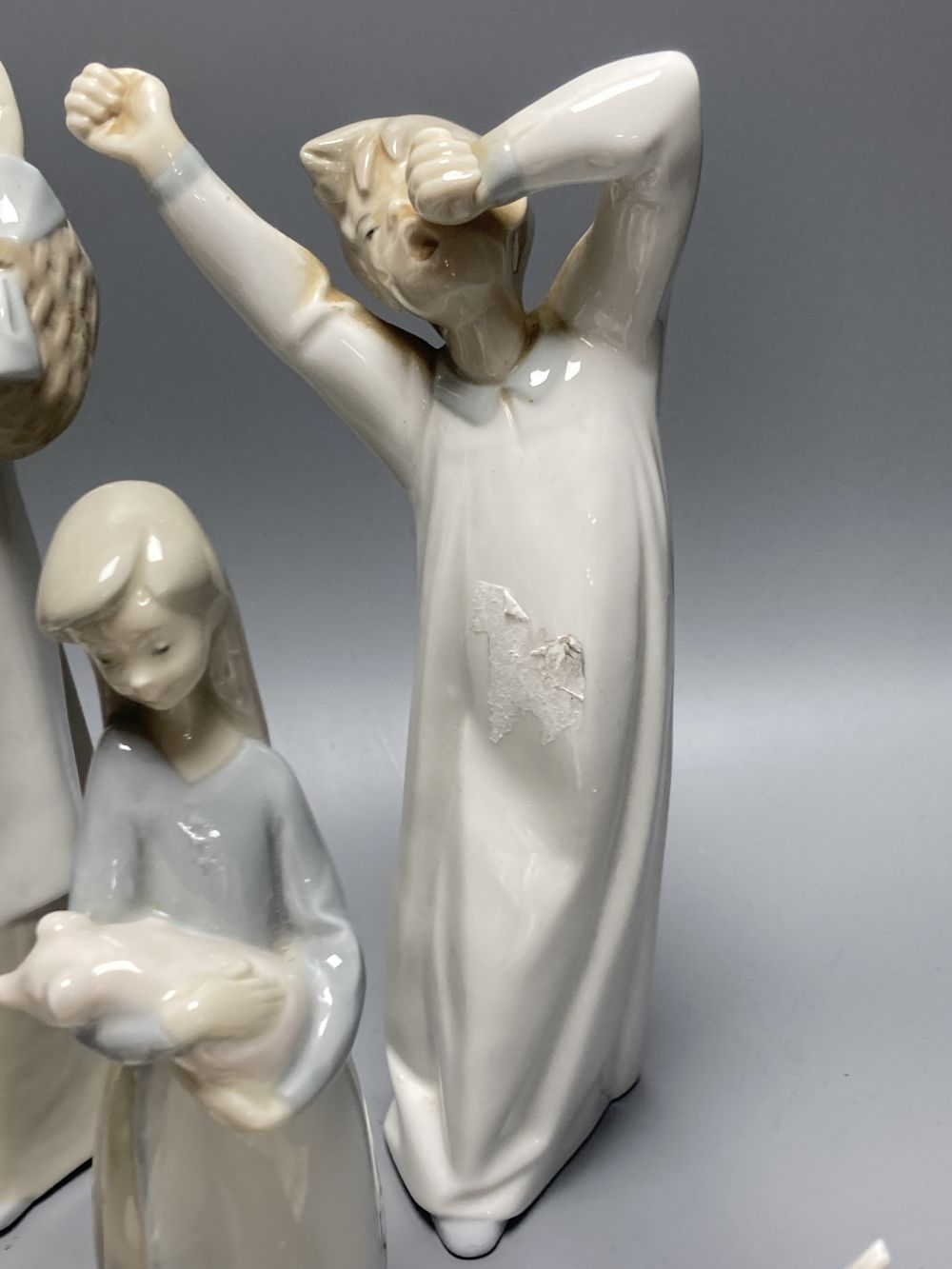 A collection of Lladro and Goebel porcelain figures and other items